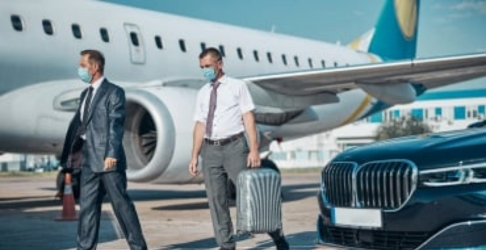 Chauffeur escorting client to private jet, showcasing premium service by Orlando airport taxi service