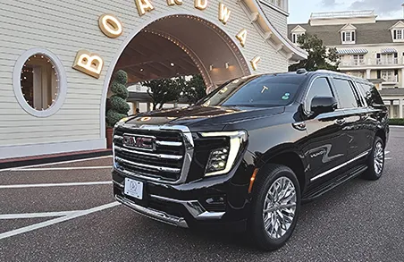 Professional black SUV car service waiting for pickup at Orlando International Airport.