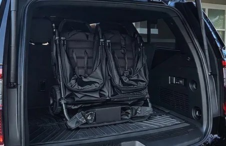 Spacious SUV trunk with ample room for airport luggage and rental strollers.